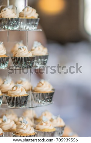 Stack of cupcakes with butter icing.
