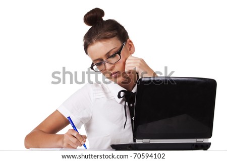 Young woman wearing glasses sitting at a table taking notes in the documents. A series of modern, airy office.