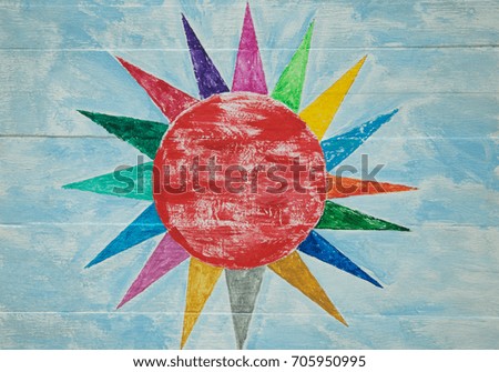 Multicolored sunburst on blue wood panel background