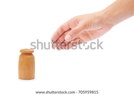 salt or paper shaker in hand isolated on white background