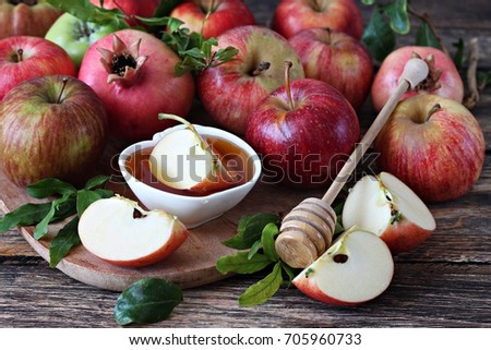 Fresh apples and pomegranate with honey jar for Rosh Hashanah 