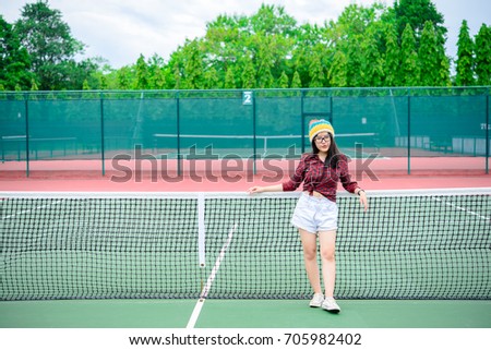 Hipster asian girl pose for take a photo,Fashion portrait pretty woman at tennis court,lifestyle of modern teenage thai girl