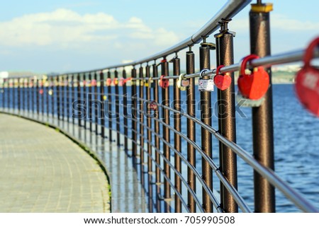 wedding locks on the fence the embankment of the river. Locks in form of heart - symbol of love