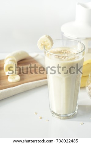 Banana smoothie. Milkshake with banana and oatmeal. Oat smoothies. Healthy breakfast. Picture with space for text or logos.