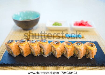 Maki roll with salmon, popular Japanese cuisine. Sushi roll with fish, cream cheese and vegetables.