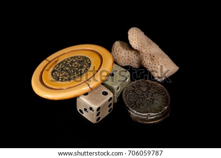 Vintage lucky charms. Antique poker chip, dice, squashed sixpences and coral. Collectable gambling tokens.