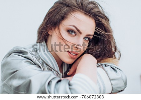 Portrait of beautiful young brunette woman with makeup