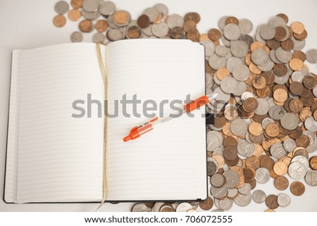 Notebook on Pile of Coins