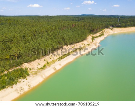 Aerial view of sand beach on lake from sandpit. Clear beautiful water for bathing and fishing. Popular destination for czech and austrian tourists. Halamky near Trebon, Czech republic, European union.
