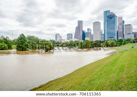 Downtown Houston at daytime with storm cloud sky and rare high water flood on Eleanor Park because of Harvey Tropical Storm. Heavy rains from hurricane Harvey caused many flooded areas in Houston