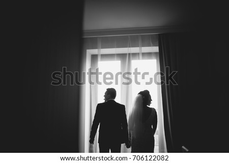 Silhouette of the bride and groom in the room