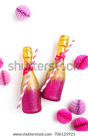 Pink and Gold Mini individual bottles for toasting of champagne with confetti and tinsel. Flat lay.  Holiday concept