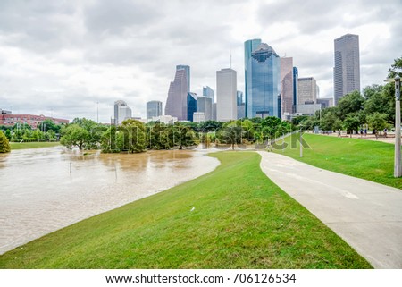 Downtown Houston at daytime with pathway and rare high water flood on Eleanor Park by Harvey Tropical Storm. Heavy rains from hurricane Harvey caused many flooded areas in greater Houston area