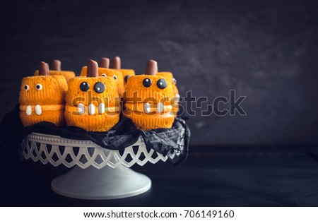 Halloween homemade cupcakes served on dark background with blank space 