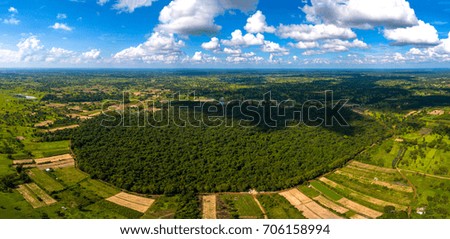 Top view Aerial photo from flying drone over Green forest.Blue sky with cloud.