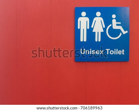 Blue label "unisex toilet" on red background