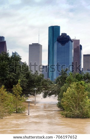 The consequences of the spill Buffalo Bayou River in Houston. Flooded park on Downtown city background. Hurricane Harvey