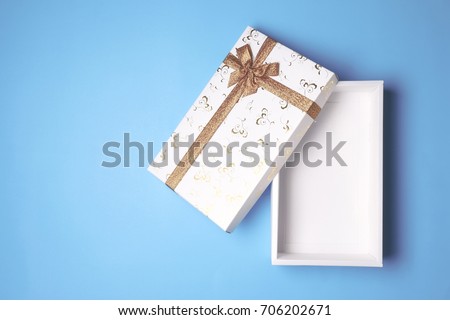 Top view of open white gift box on blue background. Free space for text Royalty-Free Stock Photo #706202671