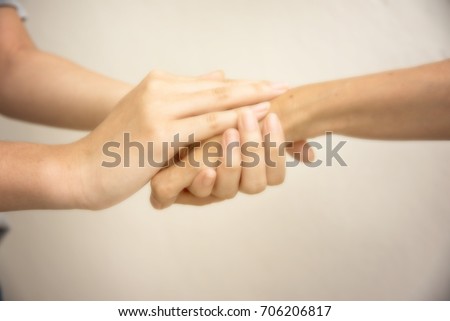 Blurry picture, Background,Young hand hold old hand together, shake hand and show concern, take care and give hope.
