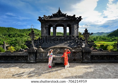 Beautiful  woman with Vietnam culture traditional dress ,Grand stairs in Imperial Khai Dinh Tomb in Hue, Vietnam  Royalty-Free Stock Photo #706214959