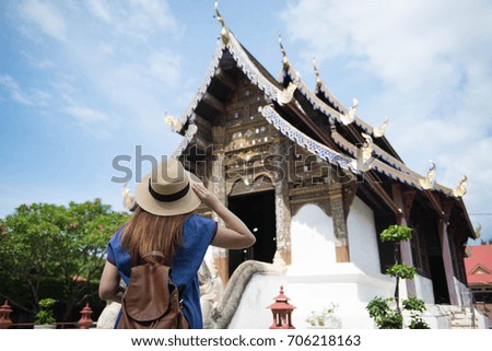 Lady tourist is watching old temple at Chiangmai, Thailand