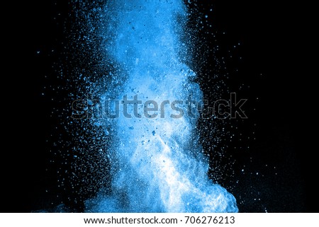 Explosion of blue dust on black background.