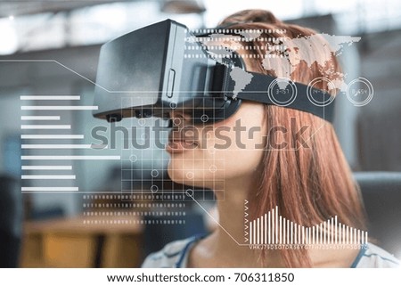Digital composite of Woman in VR headset standing behind interface