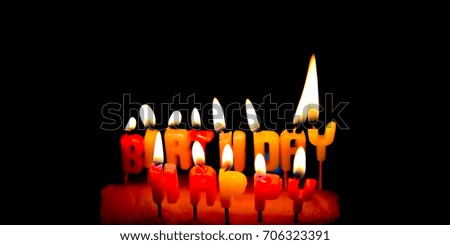 Soft Focus the happy birthday candle with flame lighting on black background.