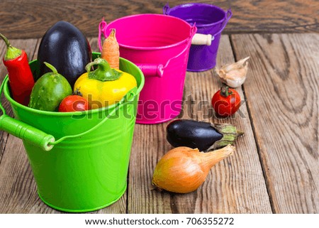 Autumn seasonal vegetables in metal bucket on wooden background. Studio Photo