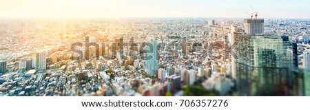 Business and culture concept - panoramic modern city skyline bird eye aerial view under dramatic sun and morning blue cloudy sky in Tokyo, Japan. Miniature Tilt-shift effect