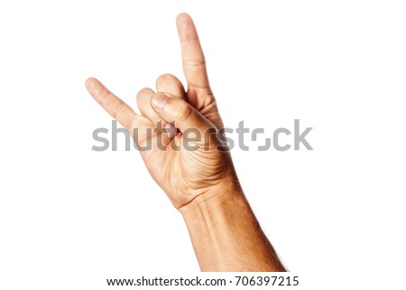 Male hand close-up on a white background shows hand gesture. Rock'n'roll. Isolate. Royalty-Free Stock Photo #706397215