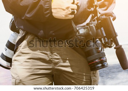 Cameraman with his video camera shooting