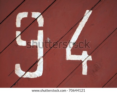 number 94 painted on a colored wood texture background pattern