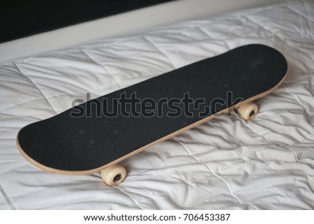 Skateboard dec on white bed sheet, classic skateboard part - closed up