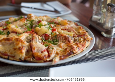 Very tasty pizza on the table and restaurant