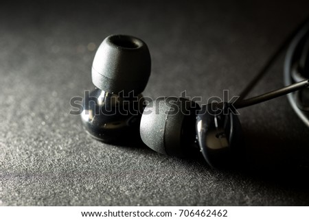 Closed up of black headphone in low key tone