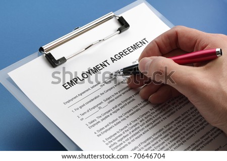 Man filling out an employment agreement contract Royalty-Free Stock Photo #70646704