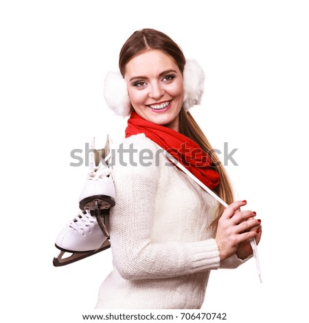 Woman with ice skates getting ready for ice skating, winter sport activity. Smiling cheerful girl wearing warm clothing on white