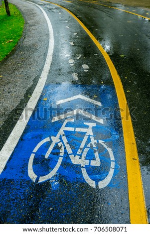 Bicycle sign on road in the park