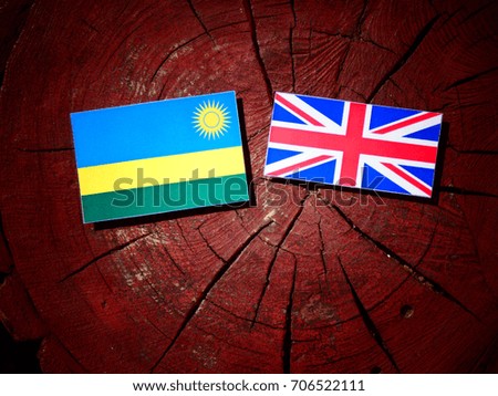Rwanda flag with British flag on a tree stump isolated