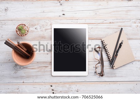 White Tablet With Blank Screen On Wooden Desk With Stationery Objects , Top View