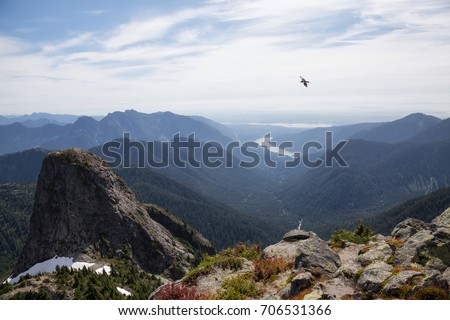 Beautiful landscape view of mountain top, valley, and Capilano Lake. Picture taken at the top of Lions Peak in Lions Bay, North of Vancouver, British Columbia, Canada.
