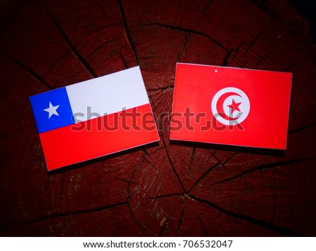 Chilean flag with Tunisian flag on a tree stump isolated
