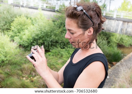 Female photographer taking photos of landscape