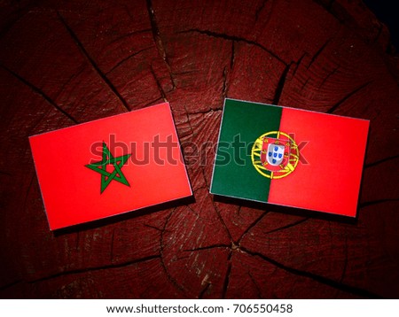 Moroccan flag with Portuguese flag on a tree stump isolated