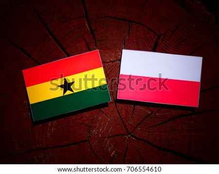 Ghanaian flag with Polish flag on a tree stump isolated