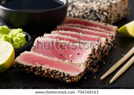 Seared ahi tuna with sesame seeds and soy sauce, wasabi, lime macro on the table. horizontal
 Royalty-Free Stock Photo #706568161