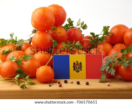 Moldovan flag on a wooden panel with tomatoes isolated on a white background