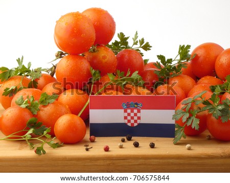 Croatian flag on a wooden panel with tomatoes isolated on a white background