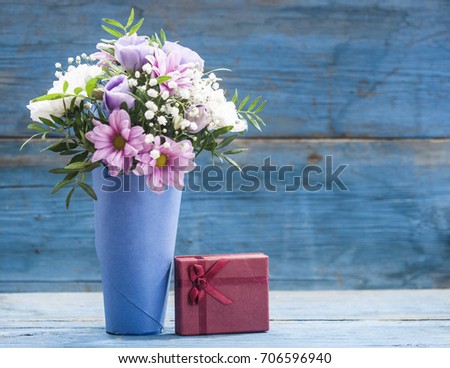 colorful flower bouquet in vase on a wooden table